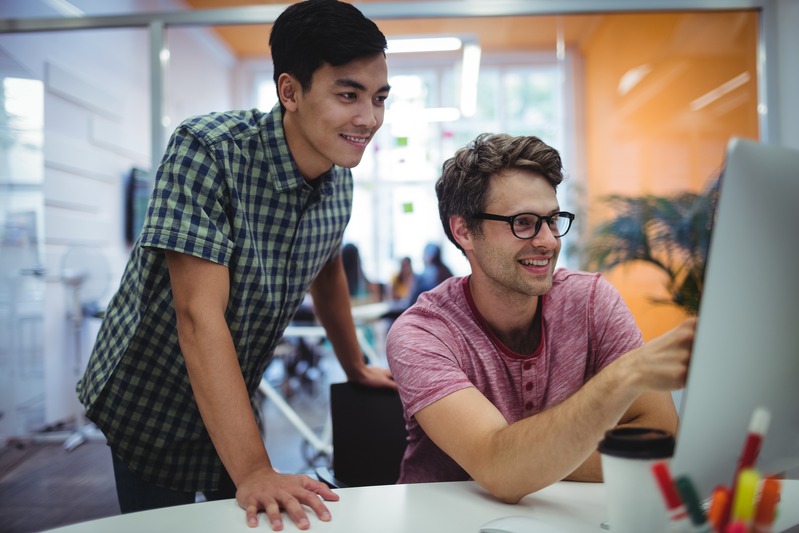 business-executives-discussing-computer-their-desk-compressed