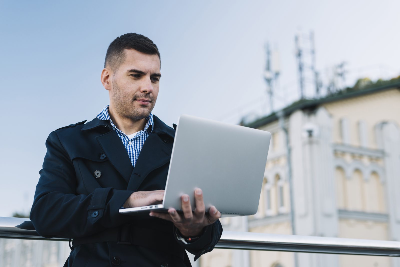 man using laptop urban environment
